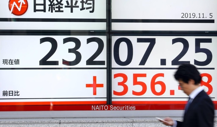 2019-11-05 00:00:00 epa07972963 A pedestrian walks past a stock market indicator board in Tokyo, Japan, 05 November 2019. Following optimism on the trade war between the US and China, Tokyo stocks gained more than 300 points in the morning trading session ( beeld anp)