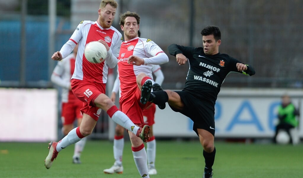 Duel om de bal tussen Eef van Riel en Danny van den Meiracker van IJsselmeervogels en Glenn Kobussen van HHC Hardenberg. (beeld orange pictures / Arnold Verkade)