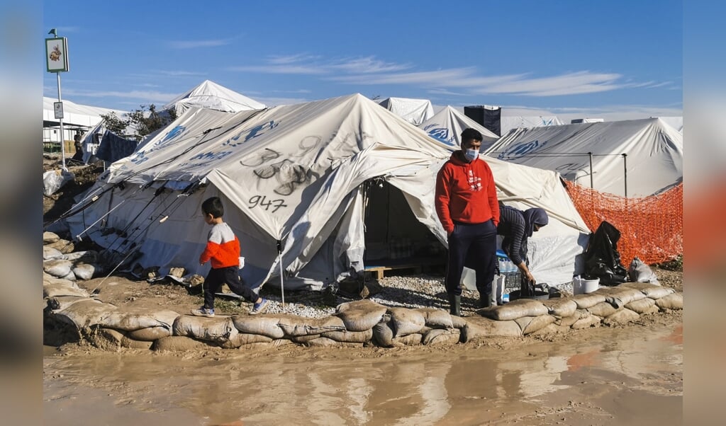 Een vluchteling voor zijn tent in het nieuwe vluchtelingenkamp op Lesbos. (beeld afp / Anthi Pazianou)