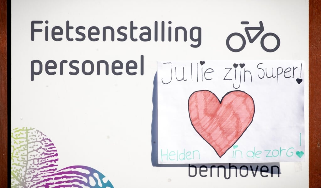 Een tekening bij de personeelsingang van het Bernhoven Ziekenhuis. In het ziekenhuis liggen veel patiënten met het coronavirus. (beeld anp / Sem van der Wal)