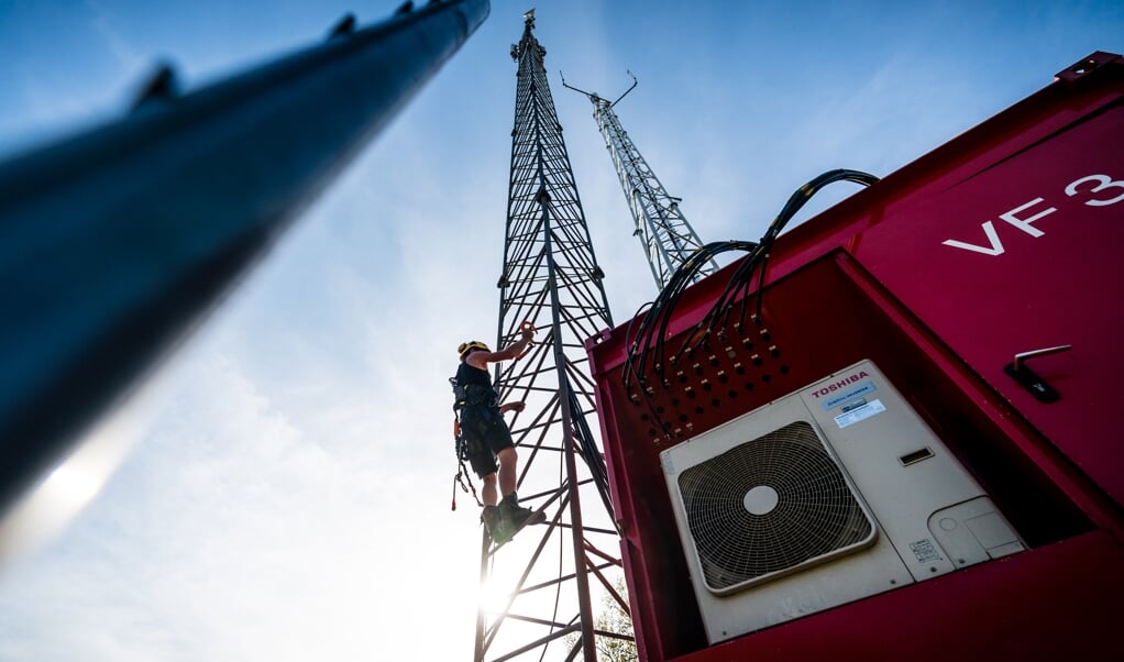 Een noodzendmast wordt opgebouwd nadat de vaste zendmast door brand vernield was. In de afgelopen maanden zijn meer zendmasten zwaar beschadigd door brand. De branden zijn vermoedelijk allemaal aangestoken Vooral de komst van een 5G-netwerk voedt angst en wantrouwen. (beeld anp / rob Engelaar)