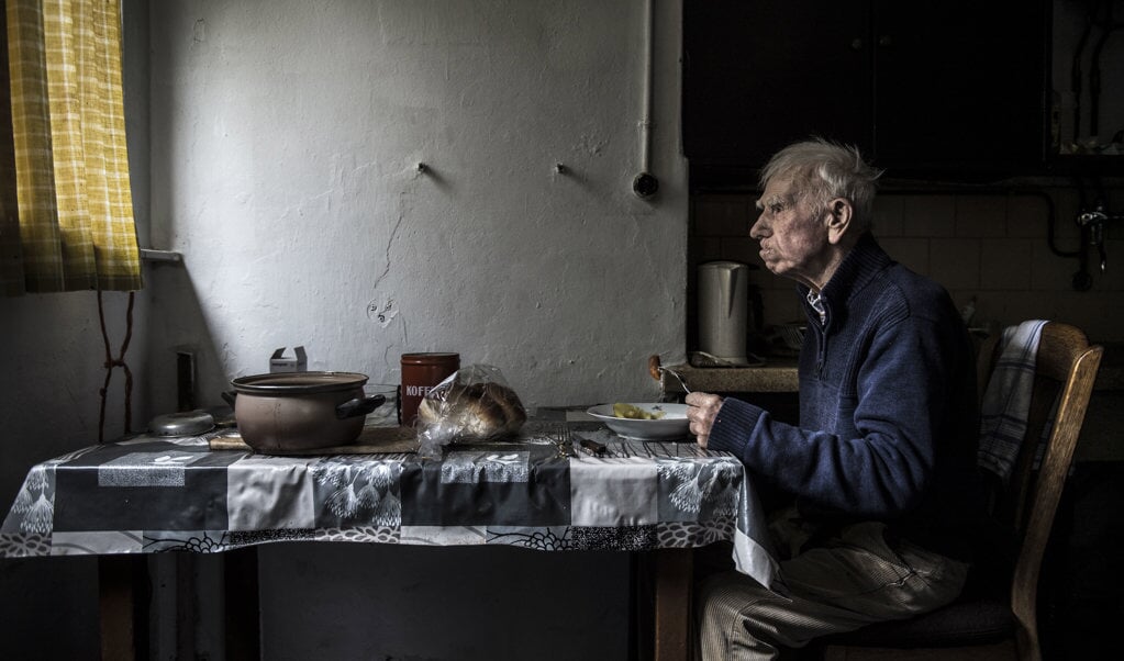 Hendrik Jan eet tussen de middag zijn warme maaltijd: aardappelen, wortels en vette worst. (beeld Carel Schutte)