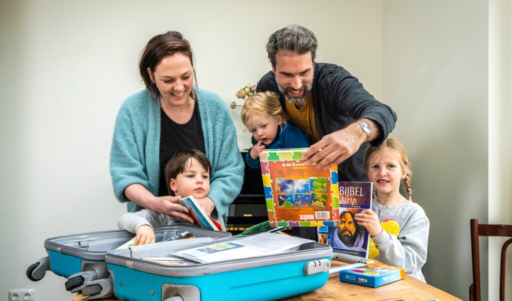 ‘Hier mogen we drie weken mee spelen!’ De familie Vegter pakt de ‘logeerkoffer’ van de Protestantse Gemeente Leiden uit. (beeld Hielco Kuipers)