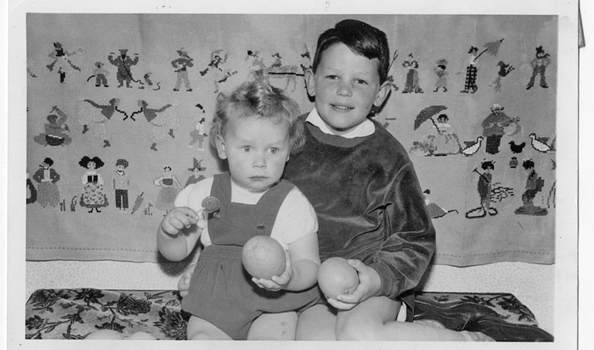 ‘Dit is een foto van mij met mijn grote broer Bertram in onze piepkleine woning aan de Tolhuisstraat in Lobith. De foto is eind jaren vijftig genomen. We hebben allebei, denk ik, een sinaasappel in de hand, waarom weet ik niet. Mijn broer is nu net met pensioen gegaan. We hebben een heel goede band samen. Mijn vader is nu ziek en mijn broer heeft de leiding in de zorg voor mijn vader en voor de familie.’