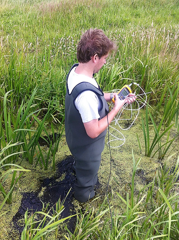 Rolf Hut (onderzoeker TU Delft) test de temperatuursensors in het waadpak. (Tim van Emmerik)
