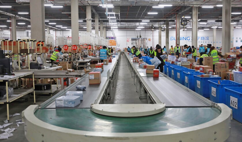 Het online winkelen en de zucht van consumenten om zo goedkoop mogelijk aan spullen te komen, daar kan een fabrikant in de eurozone bijna niet tegenop. Op de foto een distributiecentrum in China. (afp en epa / Armando Babani)