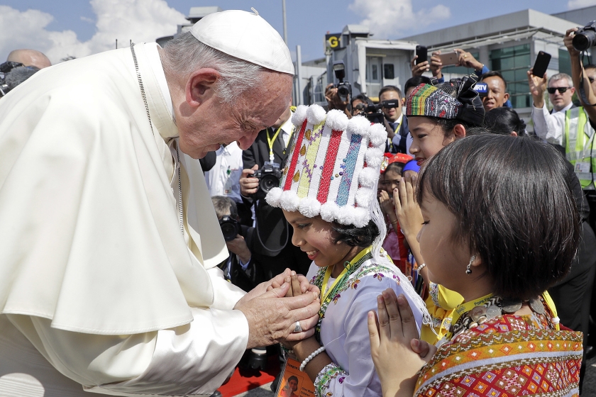 Myanmarese kinderen in traditionele kleding begroeten paus Franciscus bij zijn aankomst op de luchthaven van Yangon. De paus begon maandag aan een vierdaags bezoek aan Myanmar. Daarna reist hij verder naar Bangladesh. (ap / Andrew Medicini)