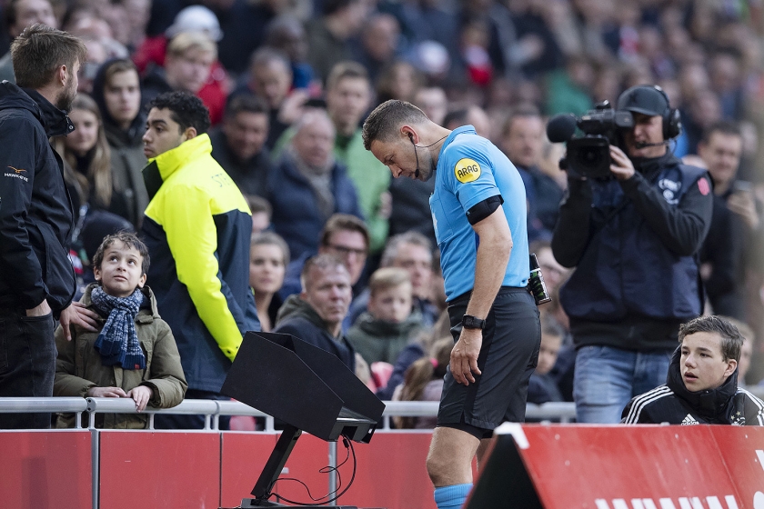Scheidsrechter Pol van Boekel raadpleegt opgenomen beelden tijdens een wedstrijd tussen Ajax en Excelsior eerder deze maand. (knvb media, afp / Christophe Simon, anp / Olaf Kraak)