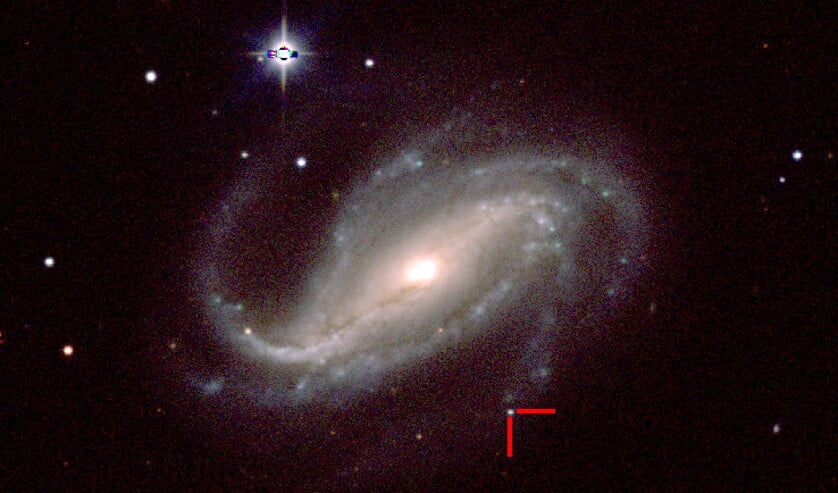 De supernova (tussen de rode balken) in het sterrenstelsel NGC 613, twee dagen na de ontdekking, gemaakt met een professionele telescoop. (university of california in santa cruz)