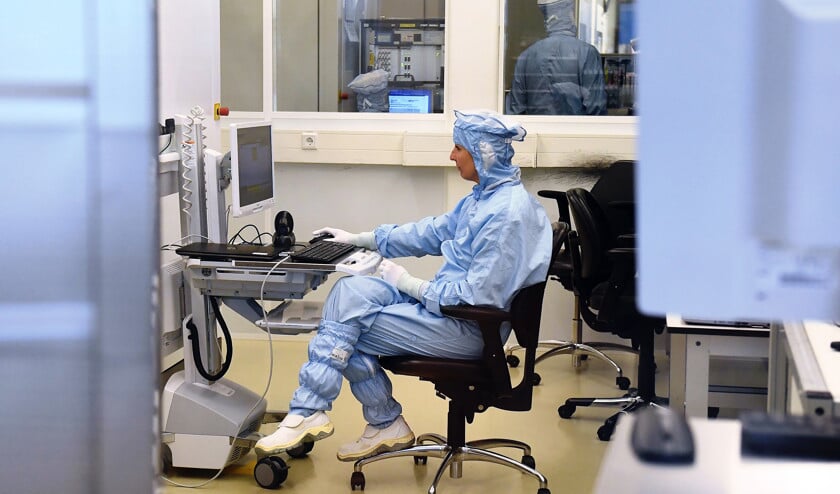 Een medewerker van ASML aan het werk in een laboratorium van de chipsmachinefabrikant. (afp / Emmanuel Dunand)