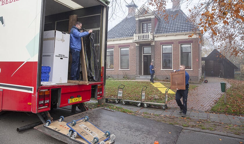 Verhuizers halen het monumentale pand van de familie Jansen in Zeerijp leeg. Op de voorpagina is het tijdelijke onderkomen van het gezin Jansen te zien. (Harry Cock)
