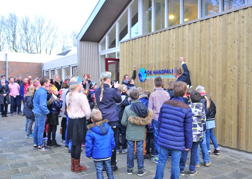 De jongste en oudste leerling van de Handpalm onthulden het nieuwe logo van de school. (Theo Zuurman en nd)